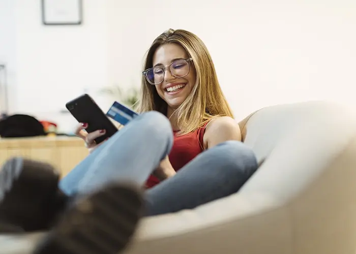 person holding phone on sofa