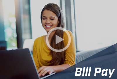 A smiling woman in a yellow top uses a laptop, with a play button overlay and 