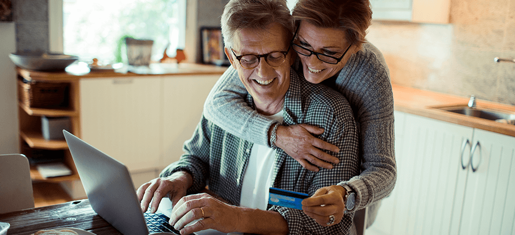 couple looking at credit card and smiling
